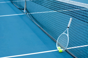 Tennis ball and racket on tennis court