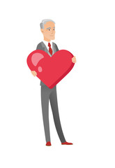 Wall Mural - Caucasian businessman holding a big red heart