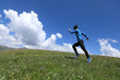© lzf - young fitness woman runner running jumping on grassland