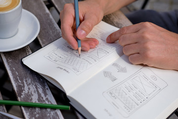 Wall Mural - man draws a sketch graphic design for website