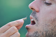 Men eating a grasshopper. Extreme survival in a nature. Food of the future