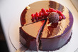 Ombre marble mousse cake decorated with red mirror glaze and berries. Modern dessert. Natural light
