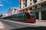 Fototapeta Miasto - a tram passing on railways between old buildings - Casablanca - Morocco