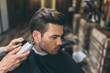 © LIGHTFIELD STUDIOS - barber cutting hair of customer
