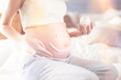 © zinkevych - Pregnant woman aplplying body cream on her belly