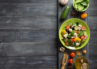 Wall Mural - fresh greek salad in plate and ingredients