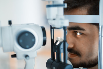 Poster - Patient or customer at slit lamp at optometrist or optician