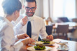 © pressmaster - Business people interacting by lunch in restaurant