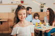 © LIGHTFIELD STUDIOS - cheerful little girl in cafe