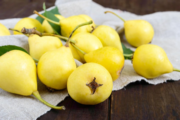 Wall Mural - A pile of yellow pears scattered on a dark wooden table. Summer Ukrainian variety 