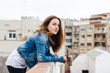 © BONNINSTUDIO/Stocksy - Portrait of beautiful young female drinking beer on a rooftop.