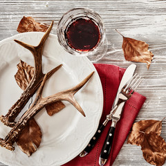 Wall Mural - deer antlers on plate served with wine