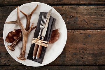 deer antlers with cutlery on plate