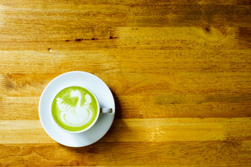 matcha latte on a wooden background in coffee shop