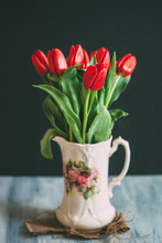 Red Tulips In Ornate Vintage Jug.