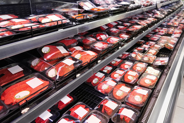 Shelves with fresh meat in supermarket