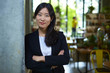 © Bo Bo/Stocksy - portrait of young asian businesswoman indoor