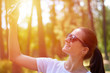 © Sviatoslav Kovtun - A young and beautiful girl in glasses does selfi in the Park during the trip. The concept of sociality and the joy of life, sunlight