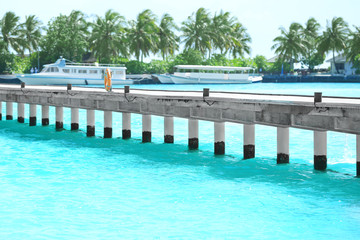 Canvas Print - Pontoon at sea resort and blurred berthed boats on background