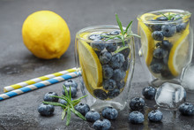 Refreshing Summer Drink With Lemon, Blueberries, Rosemary And Ice Cubes. Detox, Lemonade, Cocktail. Selective Focus