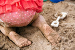 © Gabriel (Gabi) Bucataru/Stocksy - Rear of a toddler in pink polka dot swimming suit playing in the sand