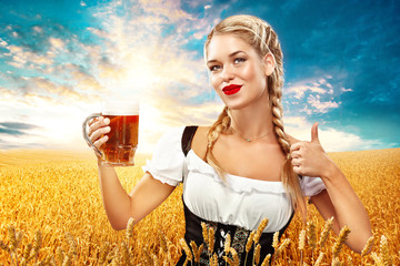 Wall Mural - Young sexy Oktoberfest waitress, wearing a traditional Bavarian dress, serving big beer mugs on blue background.