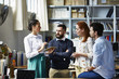 © ALTO IMAGES/Stocksy - Businesswoman Discussing With Colleagues In Office