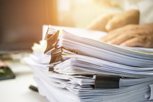 Businessman Hands Searching Information In Stack Of Papers Files On Work In Office, Business Report Paper Or Piles Of Unfinished Documents Achieves With Clips On Offices Business Concept