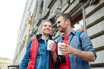 Sticker - Young guy and girl with drinks enjoying their vacation