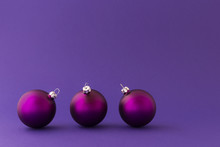 Beautiful Purple Christmas Balls With Satin Effect On Purple Background.