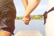 © tiagozr - Couple holding hands about to jump in the water
