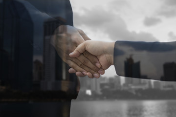 double exposure businessman shaking hand and night city, concept in corporate and communicate to success