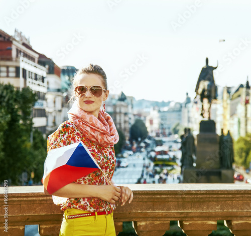 Photo traveller woman on Vaclavske namesti in Prague with Czech flag