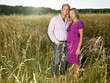 © Image Source RF - Man and pregnant wife in a field