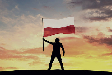 Wall Mural - Male silhouette figure waving Poland flag. 3D Rendering