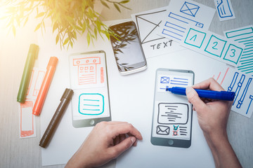 designer drawing website ux app development.