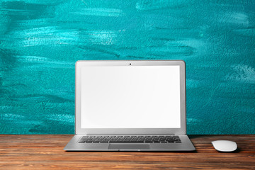 Canvas Print - Modern laptop on color background