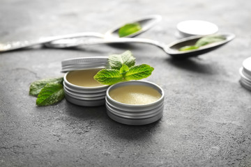 Wall Mural - Containers with lemon balm salve and leaves on table