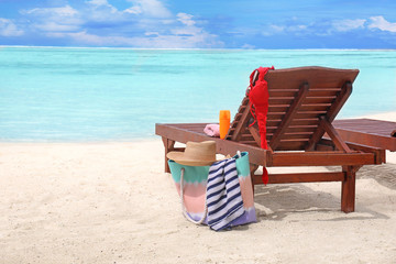 Beach accessories and sun lounger at sea resort