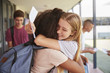© Monkey Business - Two girls celebrating exam results in school corridor