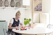 © Ulrika Kestere - Woman in overalls writes in studio
