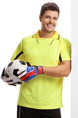 Sticker - Goalkeeper with a football leaning against a wall