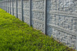 Decorative stone fence with green grass
