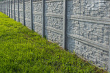Fototapeta Na ścianę - Decorative stone fence with green grass