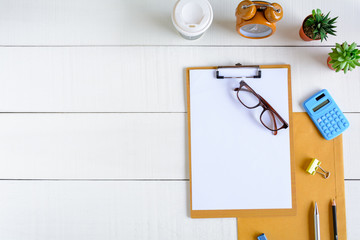 Flat lay office equipment on a white wood desk