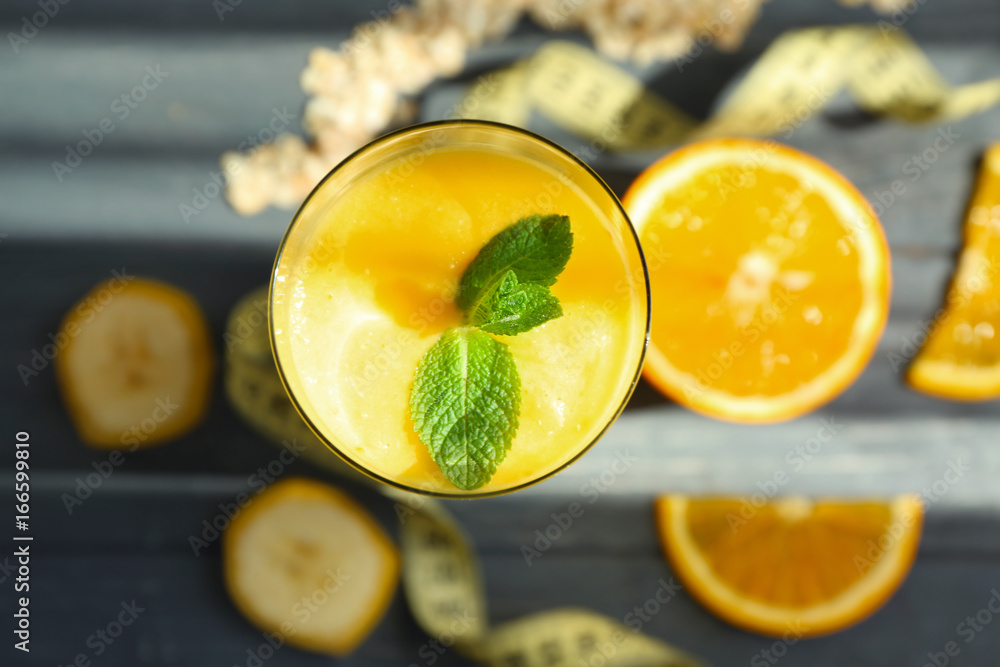 Glass with fresh tasty fruit smoothie on table