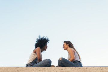 Wall Mural - Beautiful women chatting in the street.