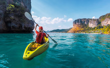 Woman Paddles Kayak In The Tropical Sea