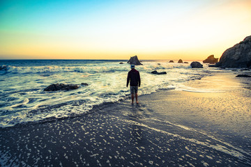 Wall Mural - man on the beach at sunset