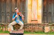 caucasian man playing violin with old house colonial style background